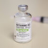 Image of a vial containing liquid Ketamine HCl, with clear labeling and transparent solution.