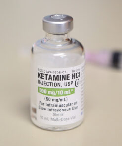 Image of a vial containing liquid Ketamine HCl, with clear labeling and transparent solution.