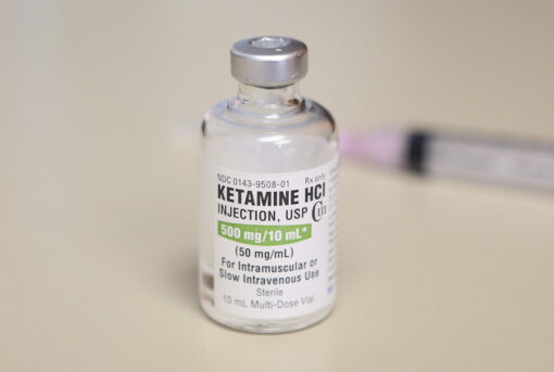 Image of a vial containing liquid Ketamine HCl, with clear labeling and transparent solution.