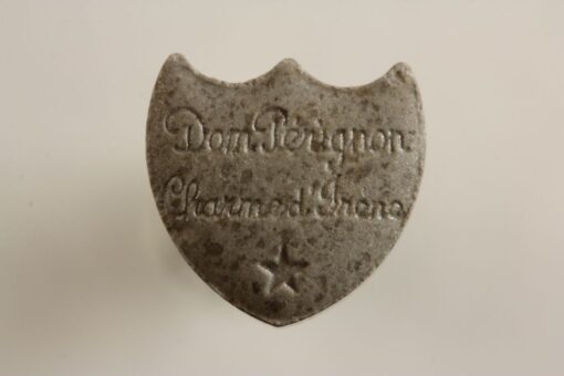 Close-up image of Dom Perignon MDMA pills with a champagne logo imprint, showcasing their premium quality and vibrant colors.